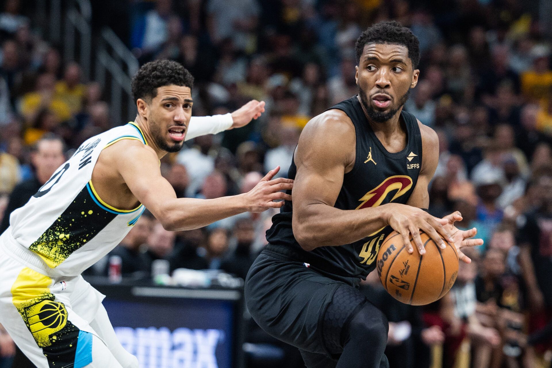 Cleveland Cavaliers guard Donovan Mitchell (45) dribbles the ball while Indiana Pacers guard Tyrese Haliburton (0) defends during game four of the second round for the 2025 NBA Playoffs at Gainbridge Fieldhouse.