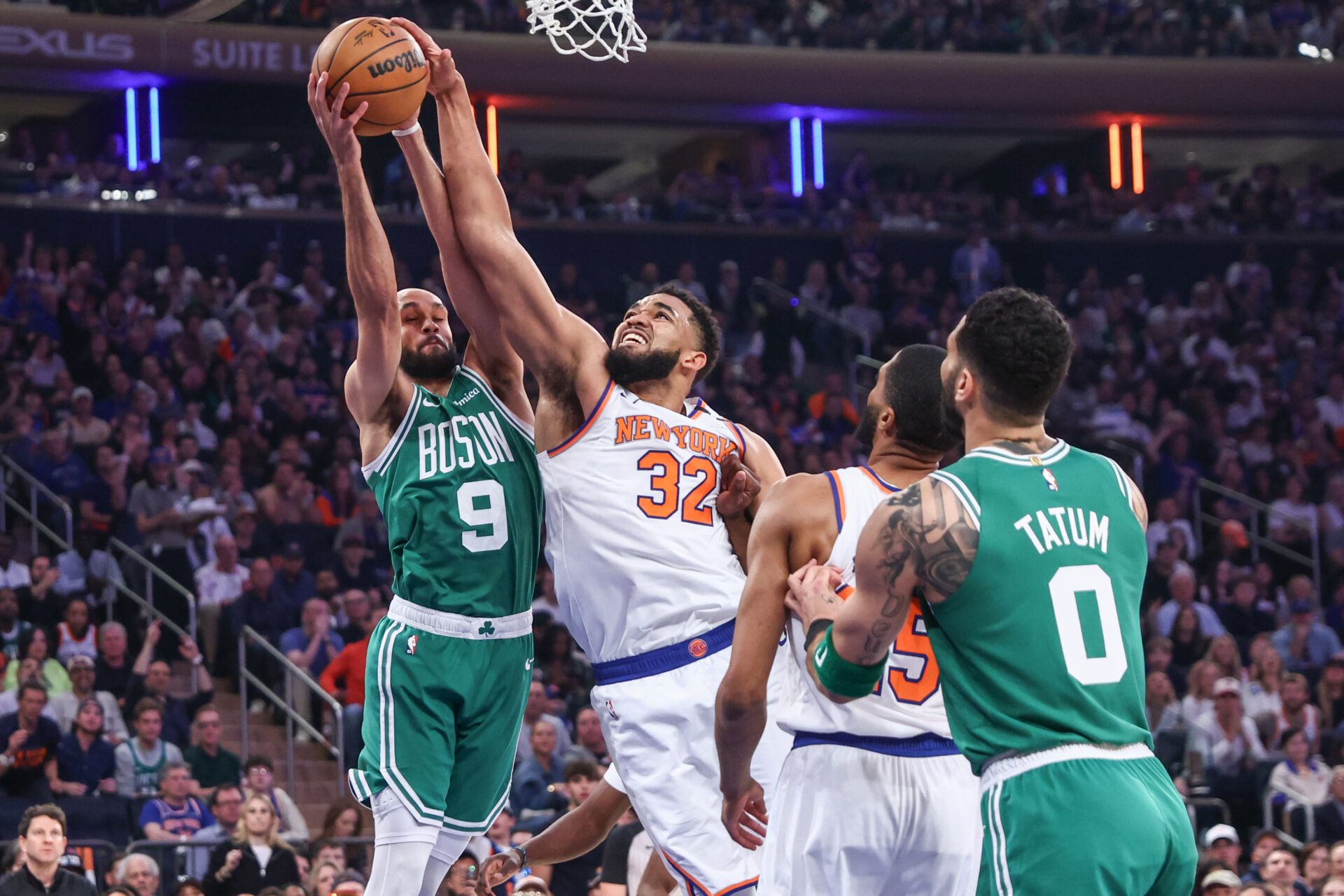 Boston Celtics guard Derrick White (9) and New York Knicks center Karl-Anthony Towns (32) fight for a rebound in the first quarter during game three of the second round for the 2025 NBA Playoffs at Madison Square Garden.
