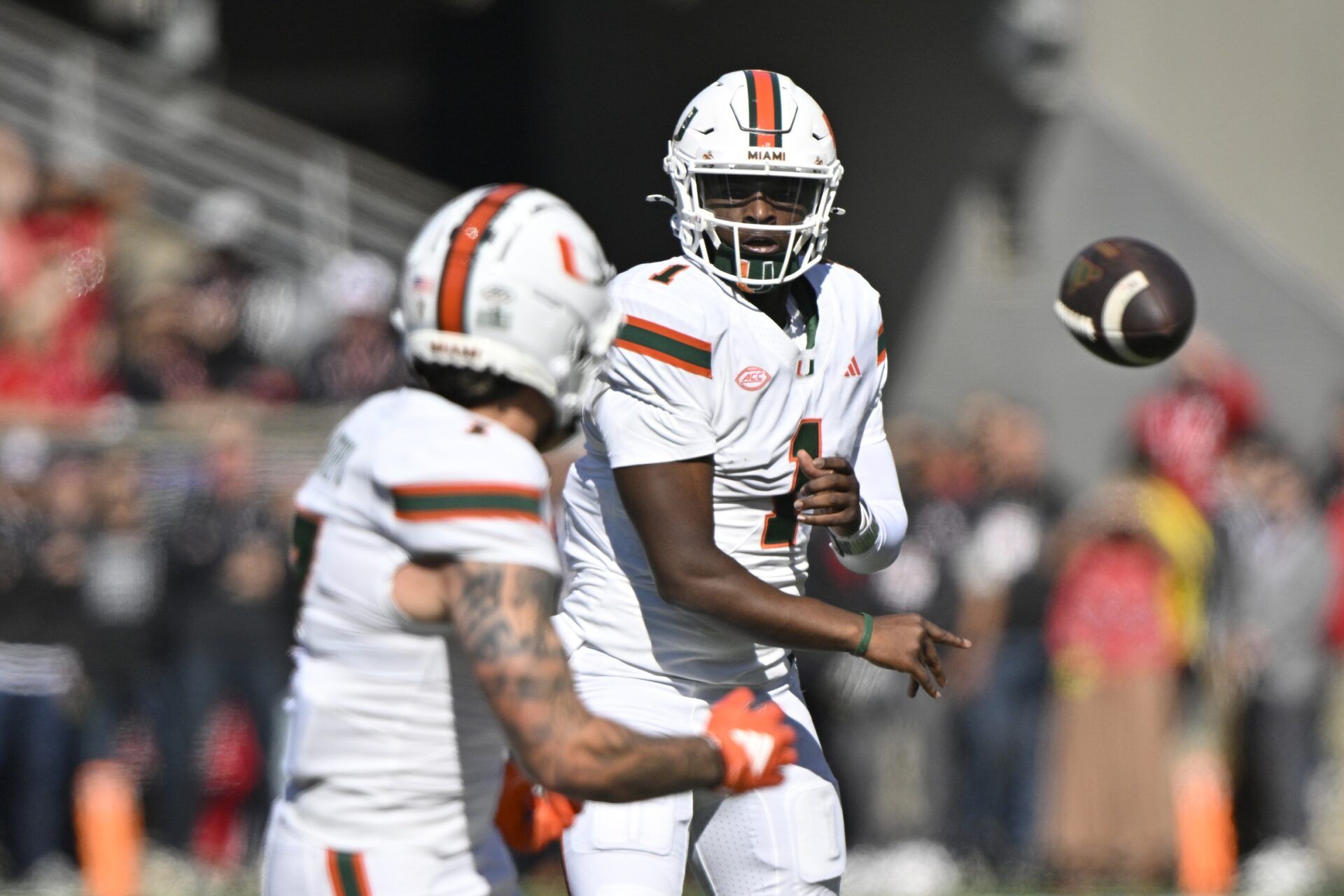 Miami Hurricanes quarterback Cam Ward (1) passes to wide receiver Xavier Restrepo (7) against the Louisville Cardinals during the first quarter at L&N Federal Credit Union Stadium.
