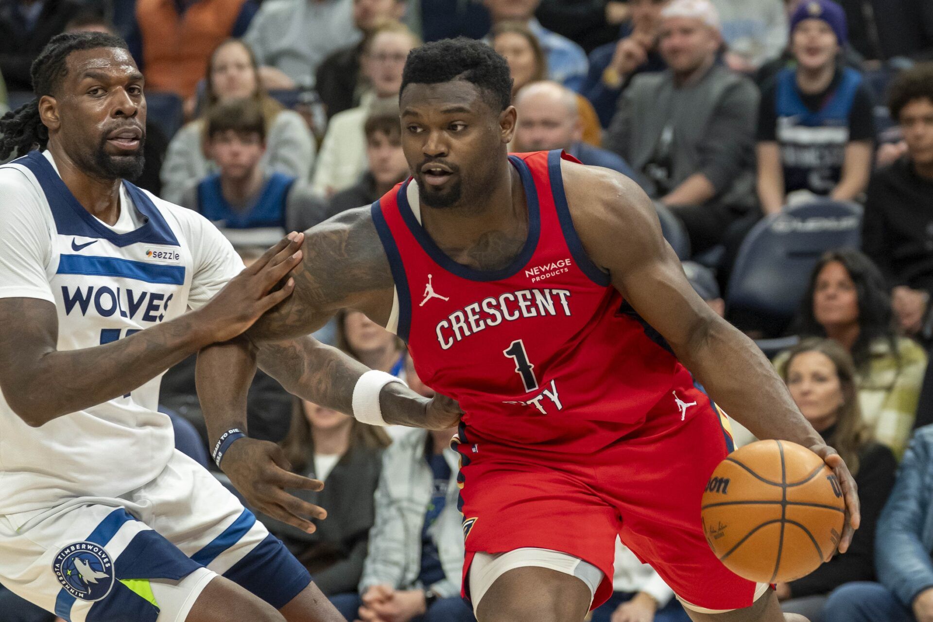 New Orleans Pelicans forward Zion Williamson (1) drives to the basket past Minnesota Timberwolves center Naz Reid (11) in the second half at Target Center.