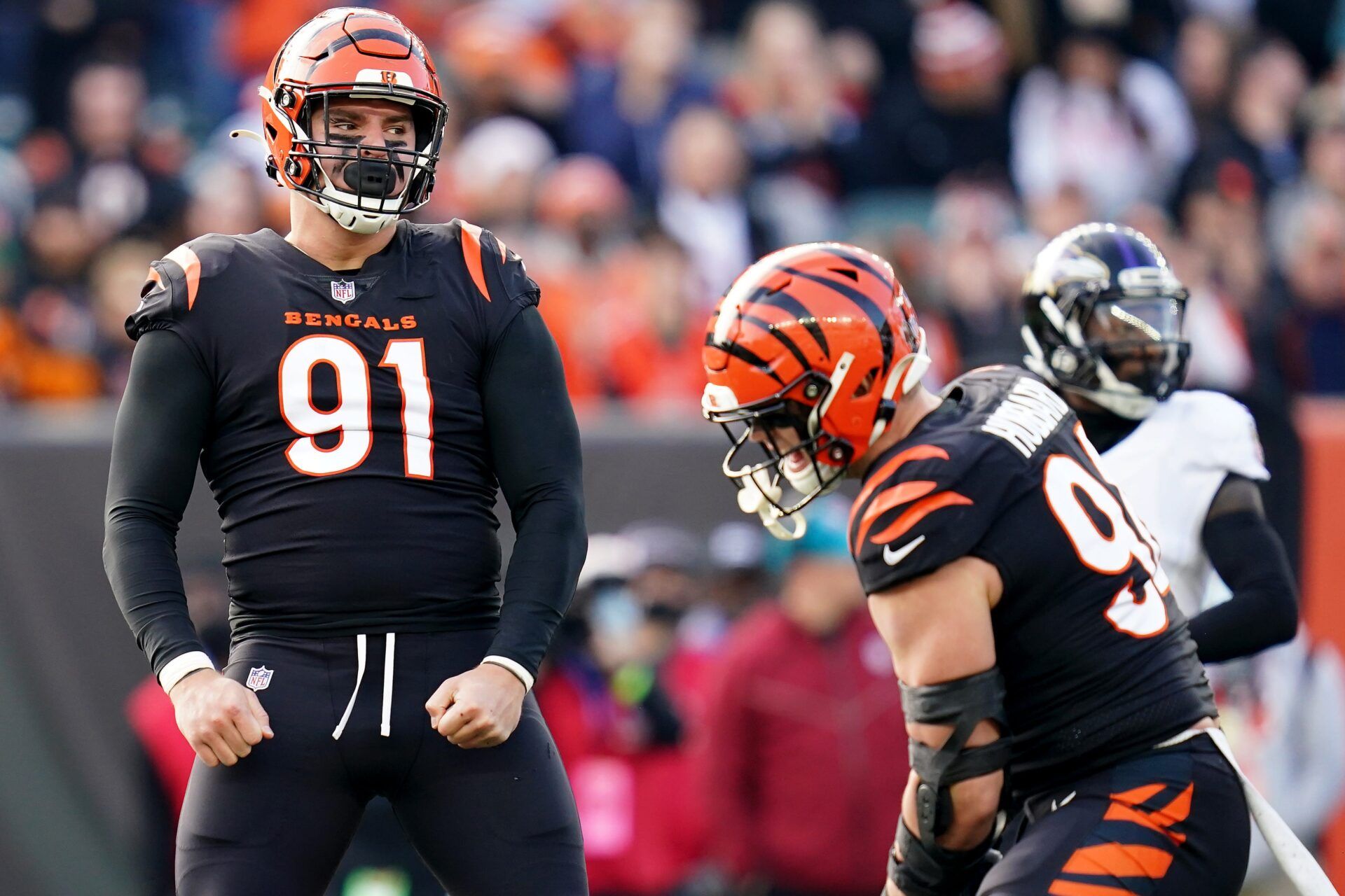 Cincinnati Bengals defensive end Trey Hendrickson (91), left, and Cincinnati Bengals defensive end Sam Hubbard (94) celebrate a sack in the second quarter during a Week 16 NFL game against the Baltimore Ravens, Sunday, Dec. 26, 2021, at Paul Brown Stadium in Cincinnati.