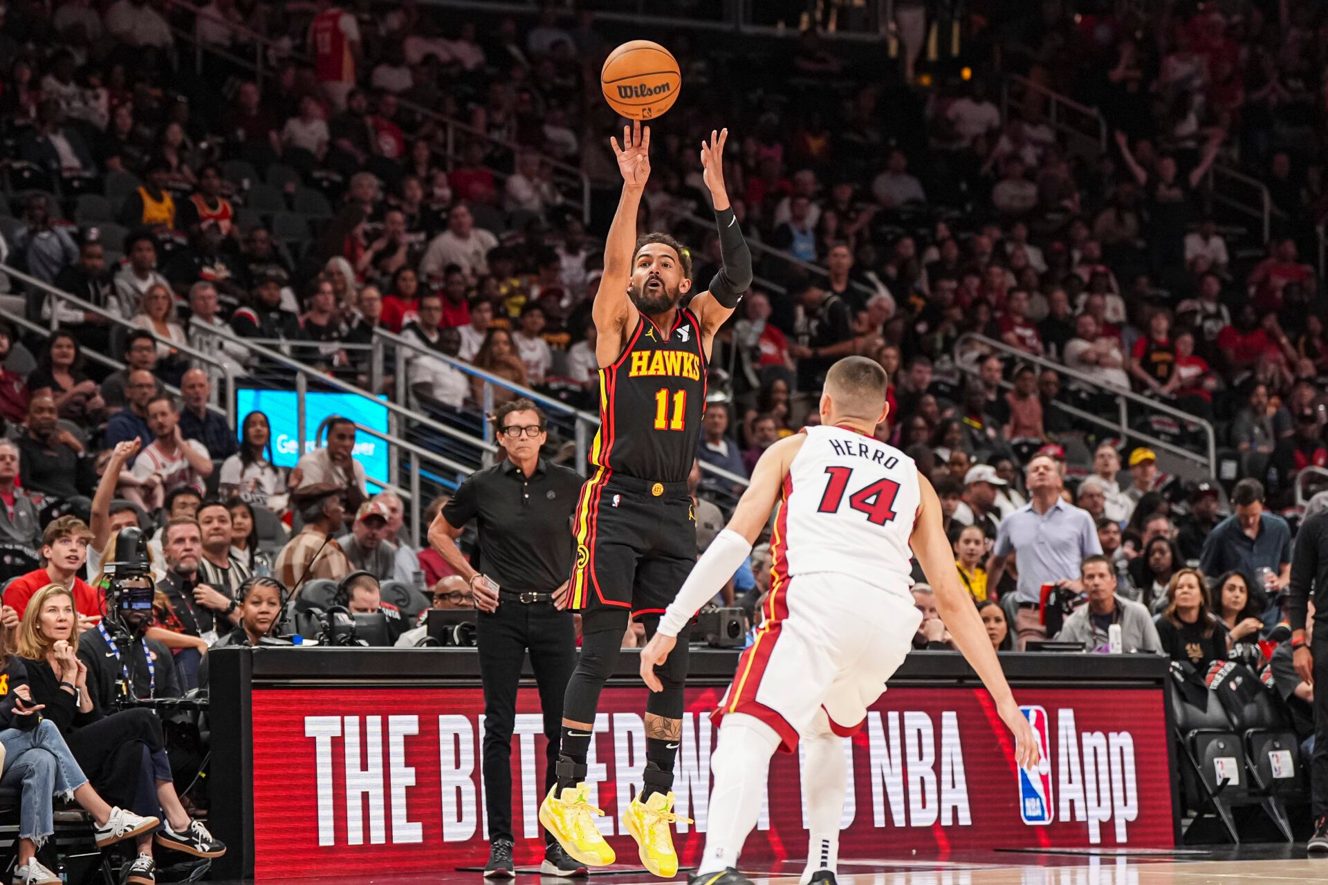 Atlanta Hawks guard Trae Young (11) shoots over Miami Heat guard Tyler Herro (14) during the first half at State Farm Arena.