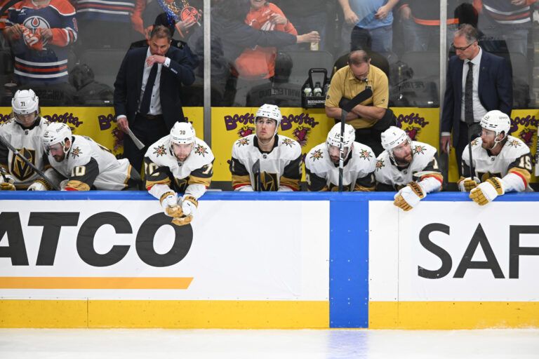 Vegas Golden Knights Head Coach Bruce Cassidy is seen on the players bench with center Nicolas Roy (10) defenseman Zach Whitecloud (2) Knights defenseman Nicolas Hague (14) and Knights defenseman Alex Pietrangelo (7) as they play the Edmonton Oilers during the third period in game three of the second round of the 2025 Stanley Cup Playoffs at Rogers Place.