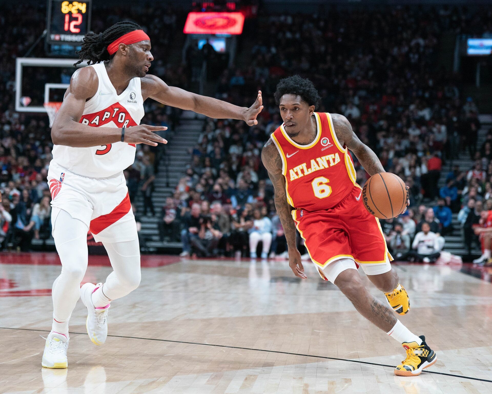 Atlanta Hawks guard Lou Williams (6) controls the ball as Toronto Raptors forward Precious Achiuwa (5) tries to defend during the second quarter at Scotiabank Arena.