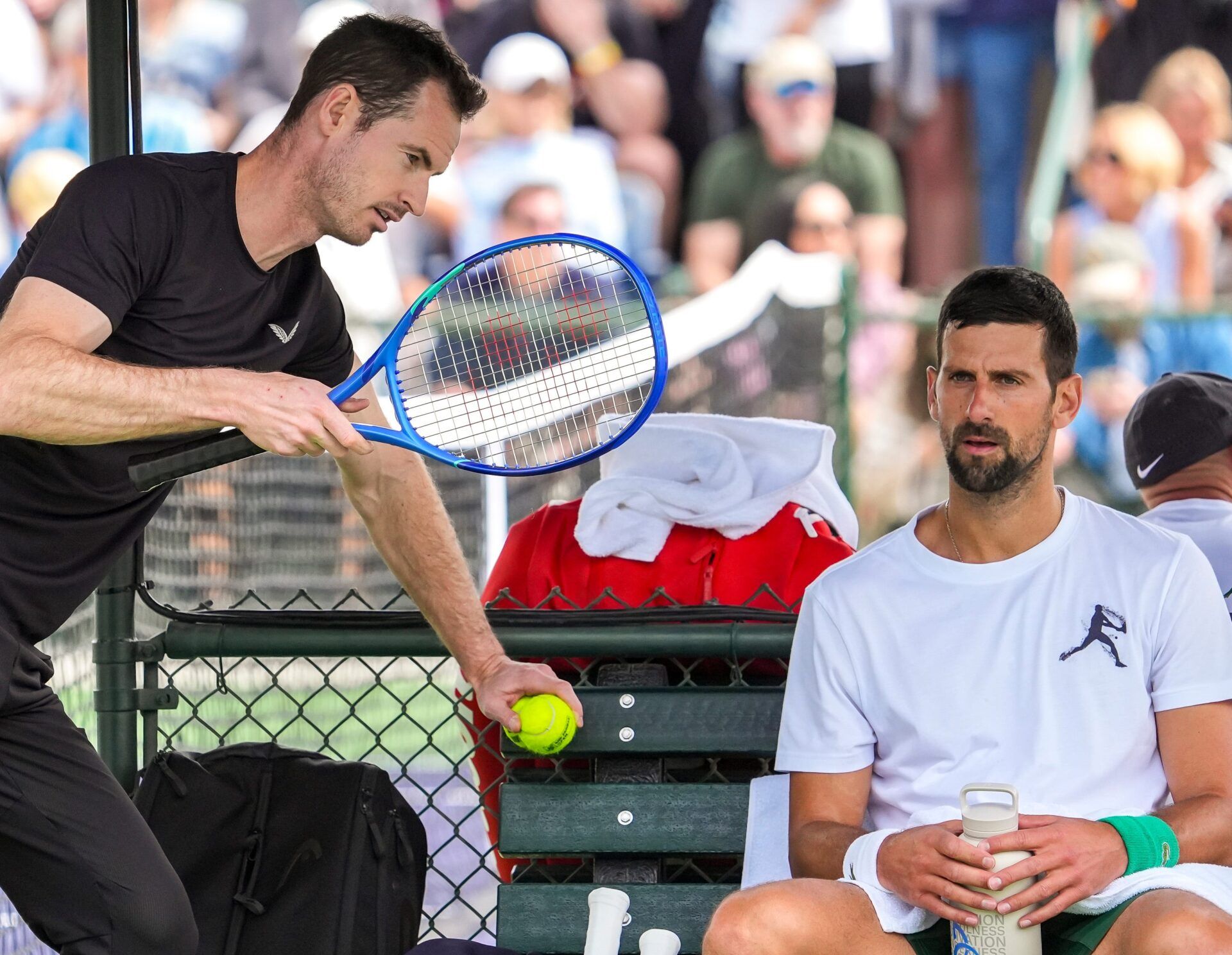 Andy Murray (left) chats with Novak Djokovic as he takes a break from his practice session at the Indian Wells Tennis Garden in Indian Wells, Calif., Wednesday, March 5, 2025.