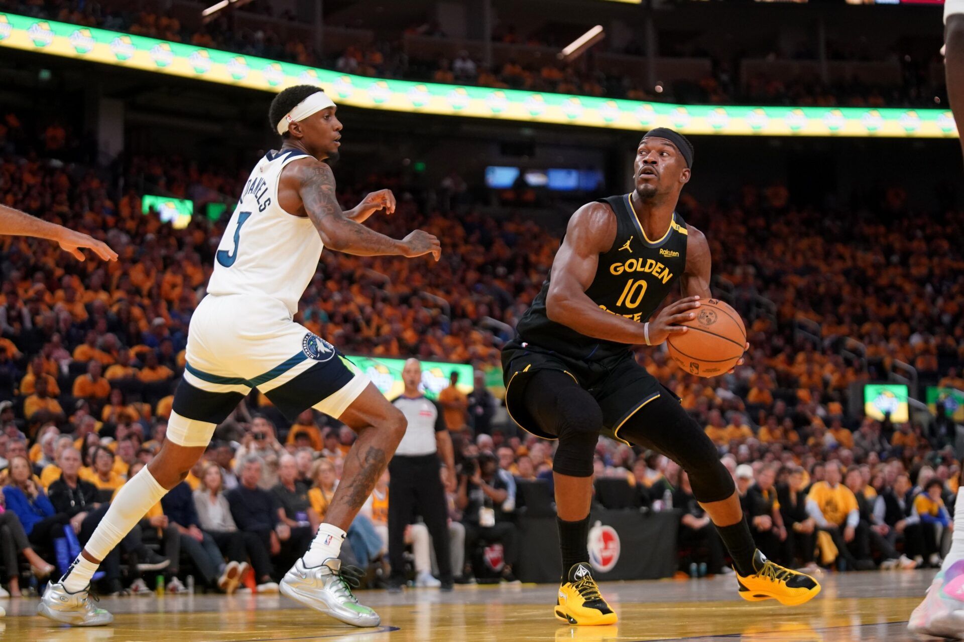 Golden State Warriors forward Jimmy Butler III (10) holds onto the ball next to Minnesota Timberwolves forward Jaden McDaniels (3) in the third quarter during game four of the second round for the 2025 NBA Playoffs at Chase Center.