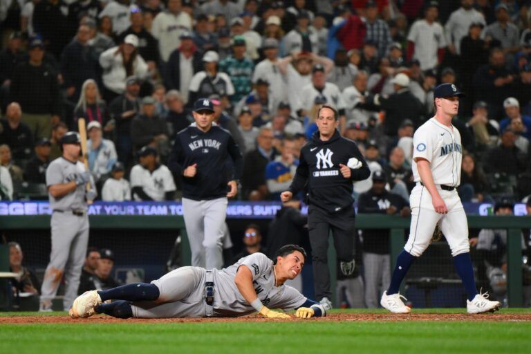 New York Yankees third baseman Oswaldo Cabrera (95) in pain after scoring a run against the Seattle Mariners during the eighth inning at T-Mobile Park.