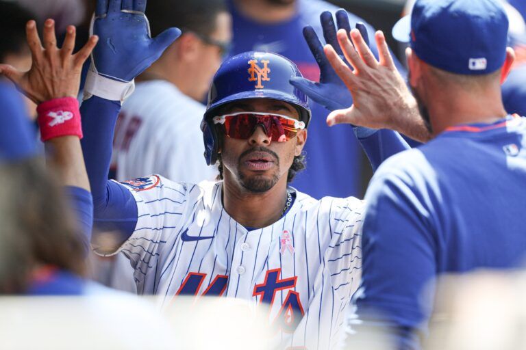 New York Mets shortstop Francisco Lindor (12) celebrates with teammates after hitting a solo home run during the eighth inning against the Chicago Cubs at Citi Field.