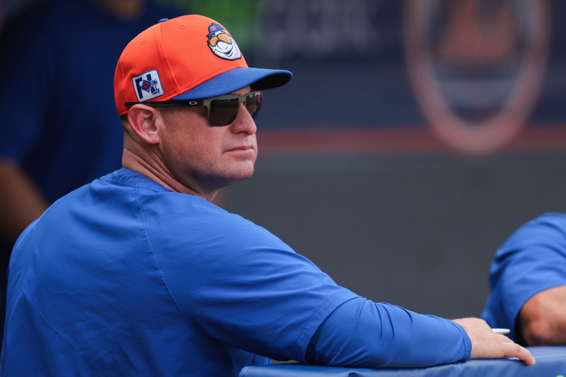 New York Mets manager Carlos Mendoza (64) looks on from inside the dugout against the New York Yankees during the third inning at Clover Park.