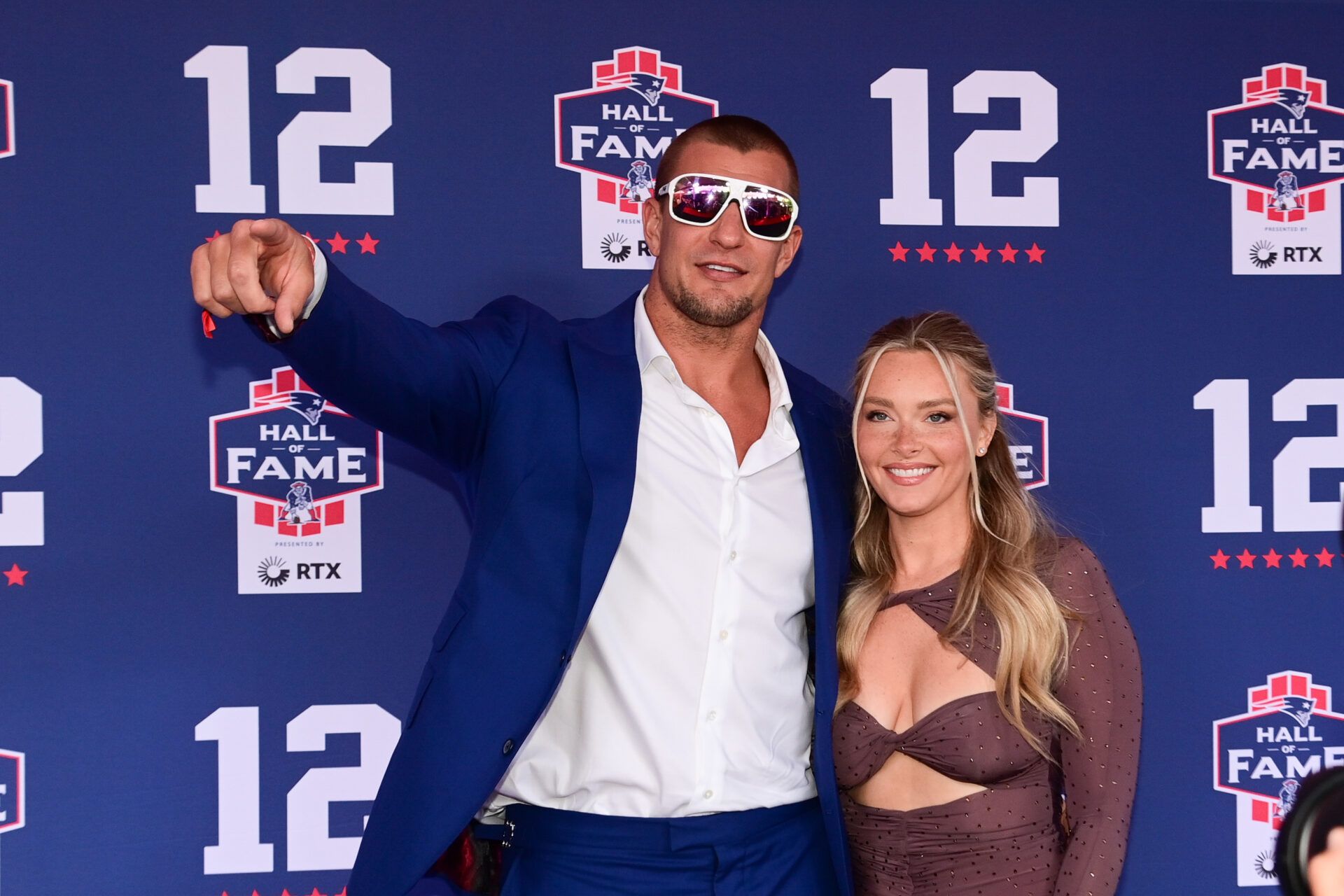 Retired NFL tight end Rob Gronkowski poses for photos with his girlfriend Camille Kostek during the New England Patriots Hall of Fame induction Ceremony for Tom Brady