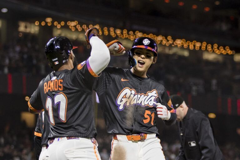 San Francisco Giants center fielder Jung Hoo Lee (51) is congratulated by left fielder Heliot Ramos (17) after he hit a three-run home run against the Arizona Diamondbacks during the eighth inning at Oracle Park.