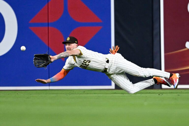 San Diego Padres center fielder Jackson Merrill (3) makes a diving catch on a ball hit by Los Angeles Angels shortstop Zach Neto (9) during the fifth inning at Petco Park.
