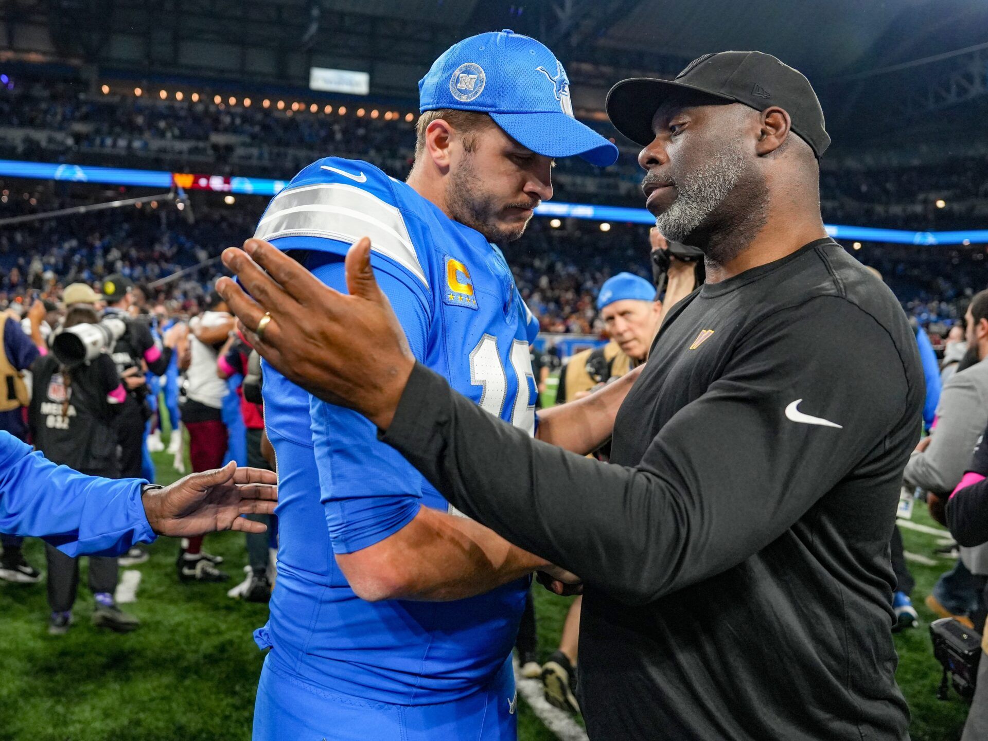 Detroit Lions quarterback Jared Goff shakes hands with Washington Commanders run game coordinator Anthony Lynn after the Lions lost the NFC divisional round playoff game 45-31 at Ford Field in Detroit, Saturday, Jan. 18, 2025.