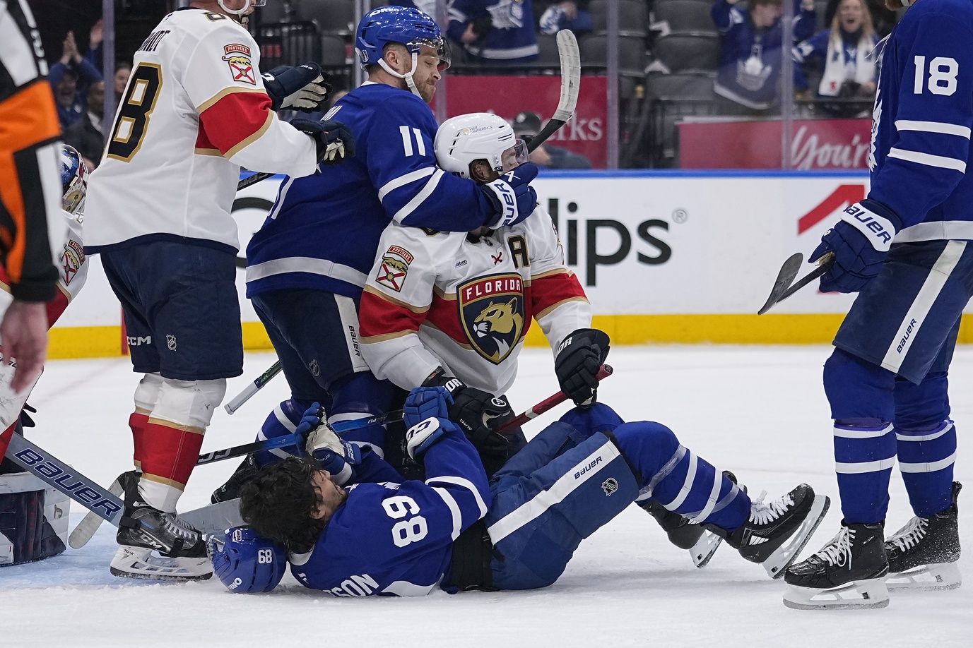 Toronto Maple Leafs forward Max Domi (11) grabs Florida Panthers defenseman Aaron Ekblad (5) after a goal by Toronto Maple Leafs forward Nicholas Robertson (89) during the third period of game five of the second round of the 2025 Stanley Cup Playoffs at Scotiabank Arena.