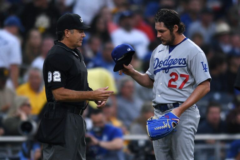 Los Angeles Dodgers starting pitcher Trevor Bauer (27) is checked for unauthorized foreign substances by umpire James Hoye (92) during the first inning at Petco Park.