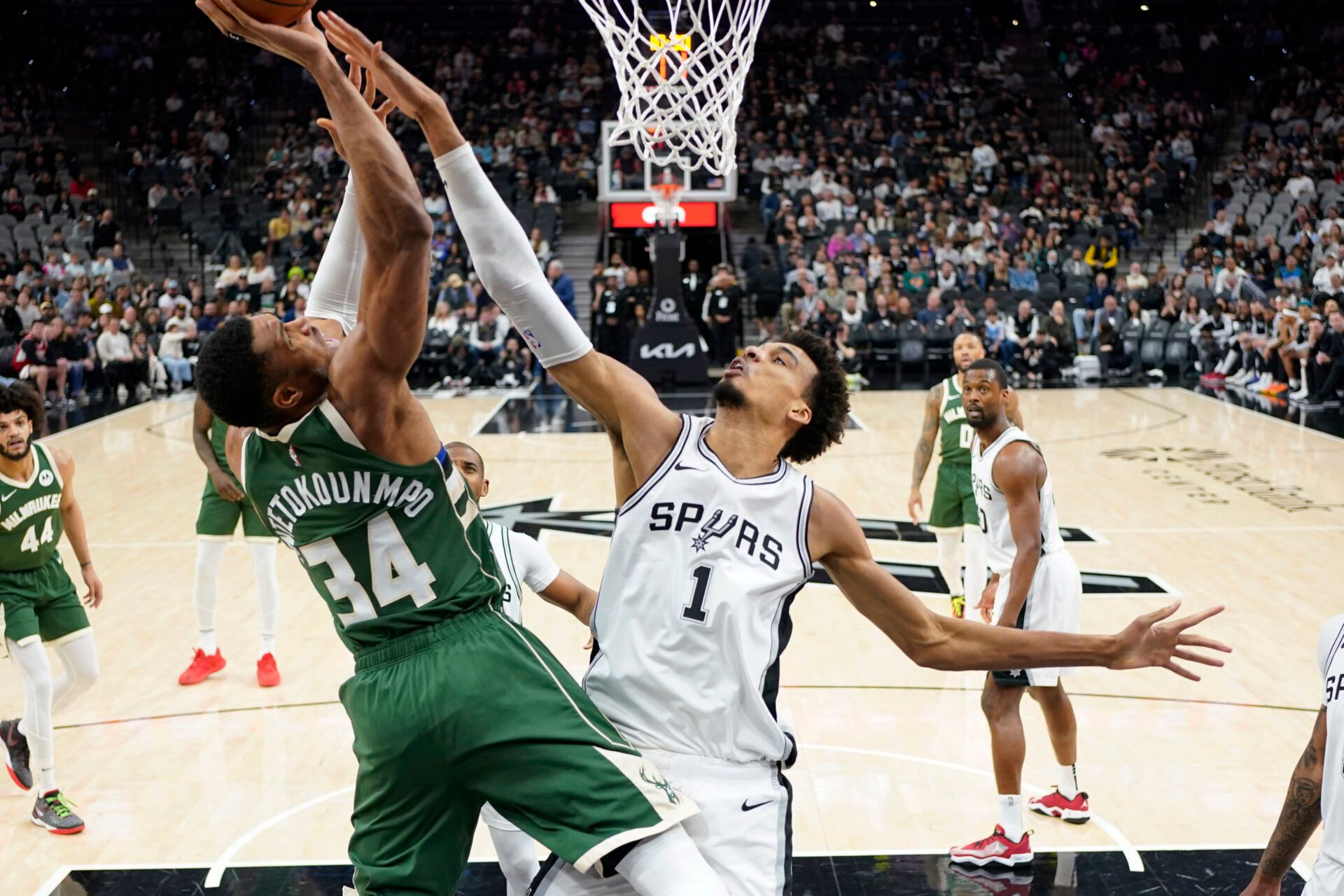 Milwaukee Bucks forward Giannis Antetokounmpo (34) goes up for a shot while defended by San Antonio Spurs center Victor Wembanyama (1) during the first half at Frost Bank Center.
