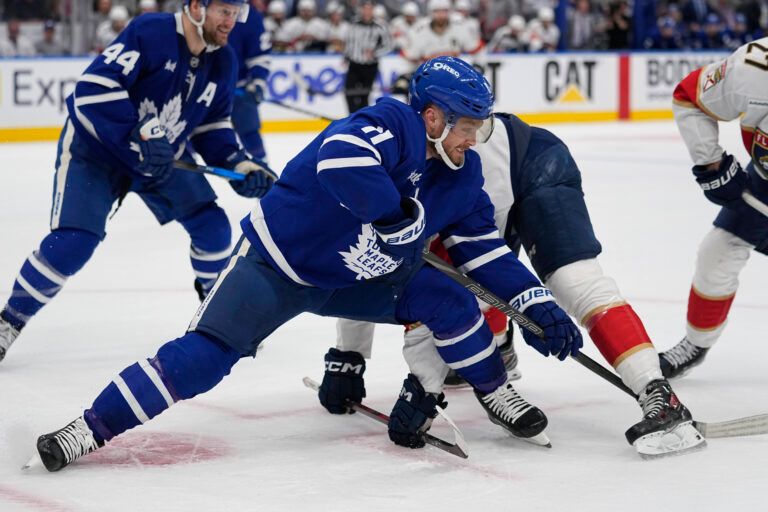 Toronto Maple Leafs forward Max Domi (11) battles to get possession of a puck against the Florida Panthers during the second period of game five of the second round of the 2025 Stanley Cup Playoffs at Scotiabank Arena.