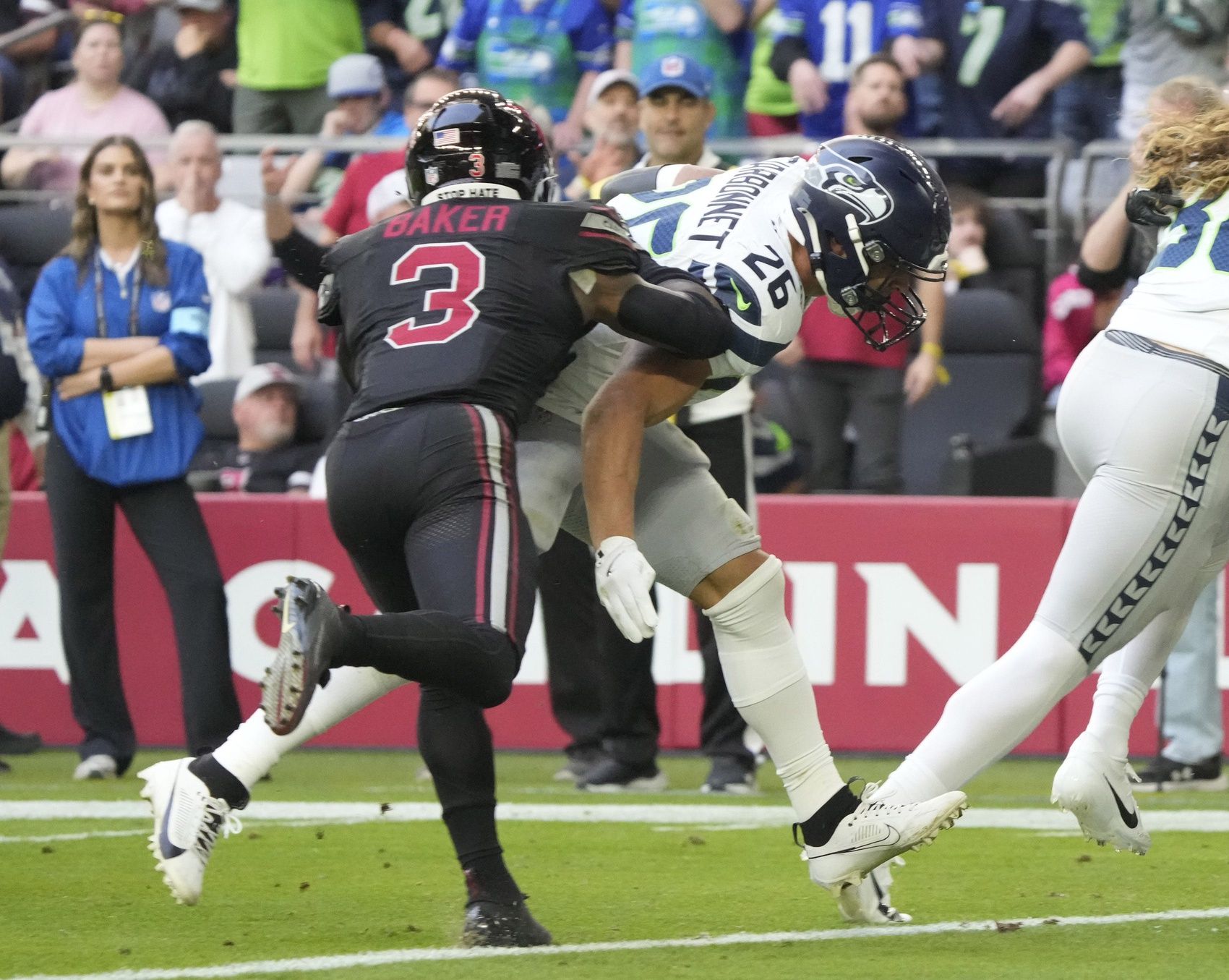 Seattle Seahawks running back Zach Charbonnet (26) scores a touchdown ahead of Arizona Cardinals safety Budda Baker (3) during the second quarter at State Farm Stadium in Glendale on Dec. 8, 2024.

© Michael Chow/The Republic / USA TODAY NETWORK via Imagn Images