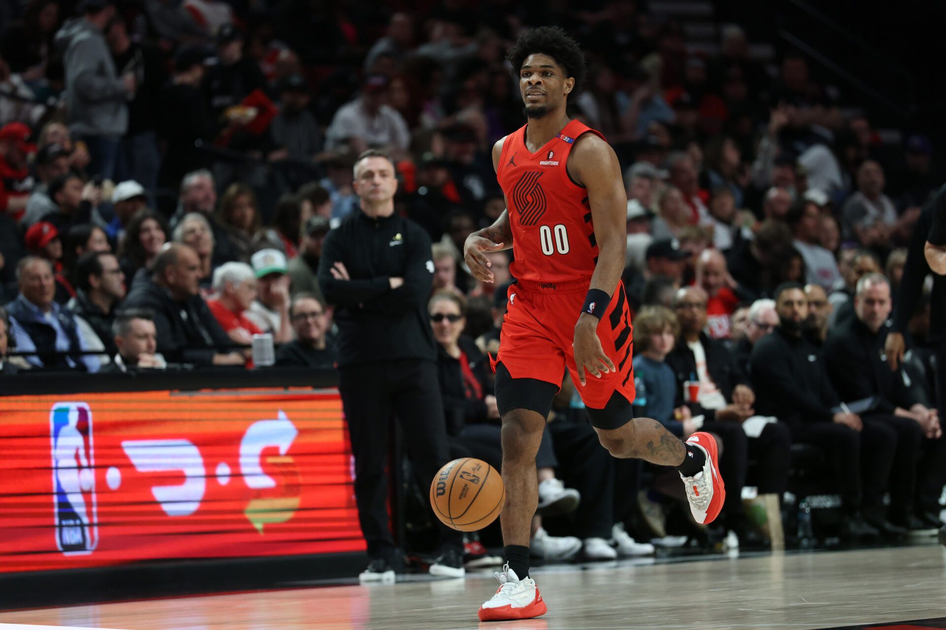 Portland Trail Blazers guard Scoot Henderson (00) brings the ball up the court against the Toronto Raptors in the second half at Moda Center.
