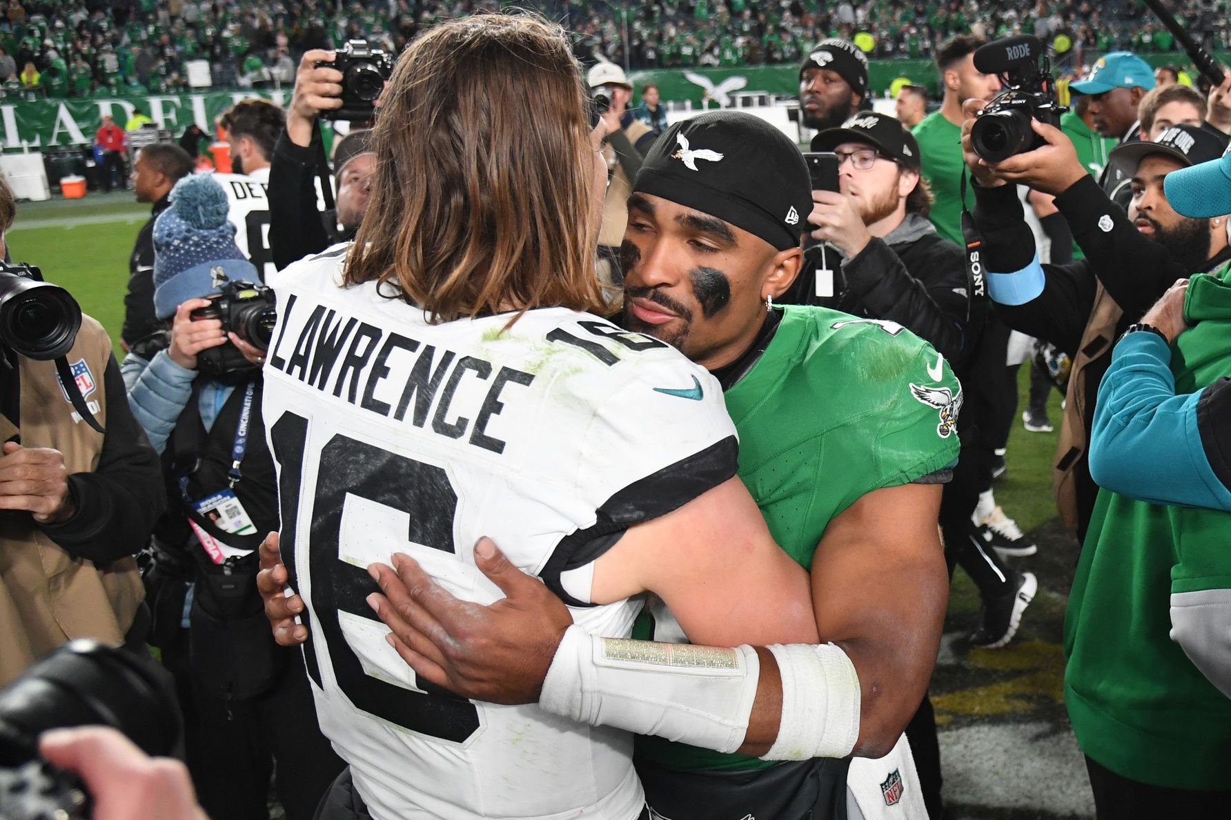 Jacksonville Jaguars quarterback Trevor Lawrence (16) and Philadelphia Eagles quarterback Jalen Hurts (1) meet on the field after the game at Lincoln Financial Field.
