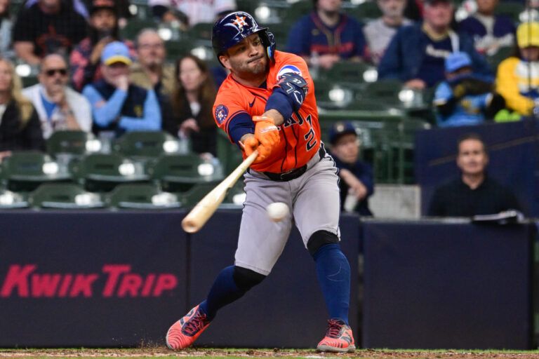 Houston Astros designated hitter Jose Altuve (27) hits an infield single in the ninth inning against the Milwaukee Brewers at American Family Field.