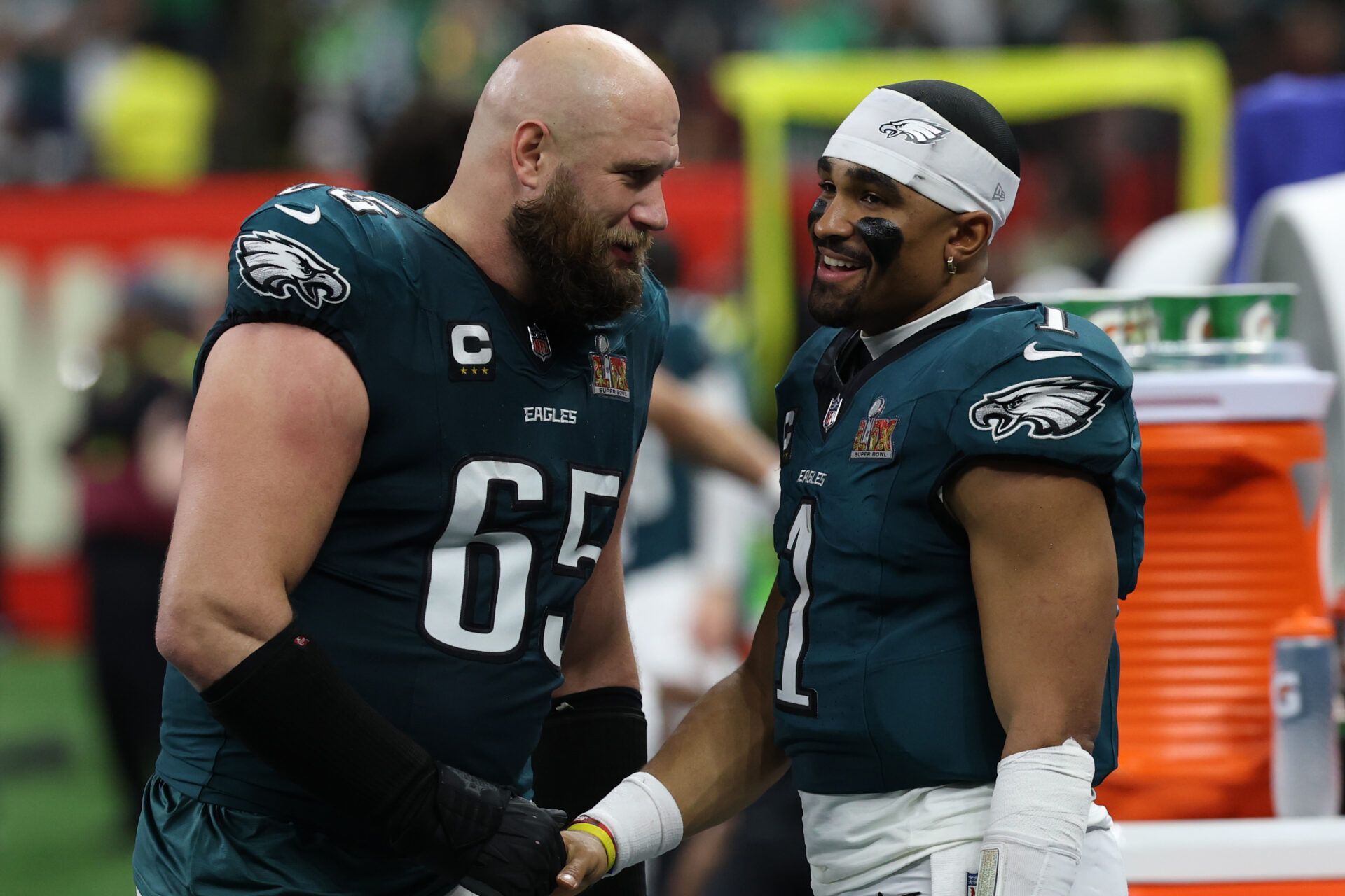 Philadelphia Eagles quarterback Jalen Hurts (1) celebrates with Eagles offensive tackle Lane Johnson (65) on the bench during the fourth quarter of Super Bowl LIX against the Kansas City Chiefs at Caesars Superdome.