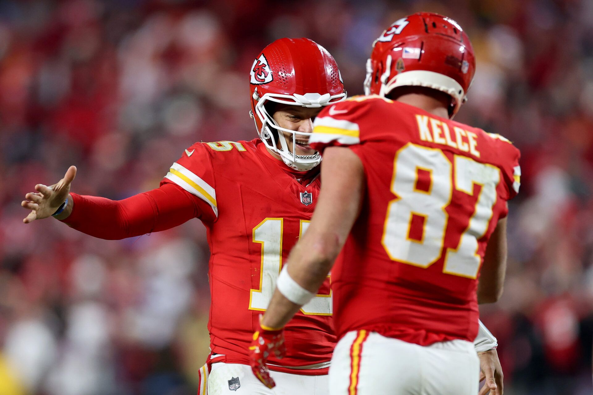 KANSAS CITY, MISSOURI - DECEMBER 08: Patrick Mahomes #15 of the Kansas City Chiefs celebrates with Travis Kelce #87 during the fourth quarter against the Los Angeles Chargers at GEHA Field at Arrowhead Stadium on December 08, 2024 in Kansas City, Missouri. (Photo by Jamie Squire/Getty Images)