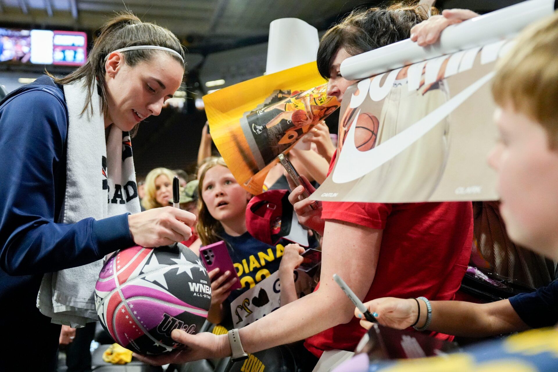 Indiana Fever guard Caitlin Clark (22) signs autographs for fans after the Fever defeated Brazil in a preseason game May 4, 2025 at Carver-Hawkeye Arena in Iowa City, Iowa.
