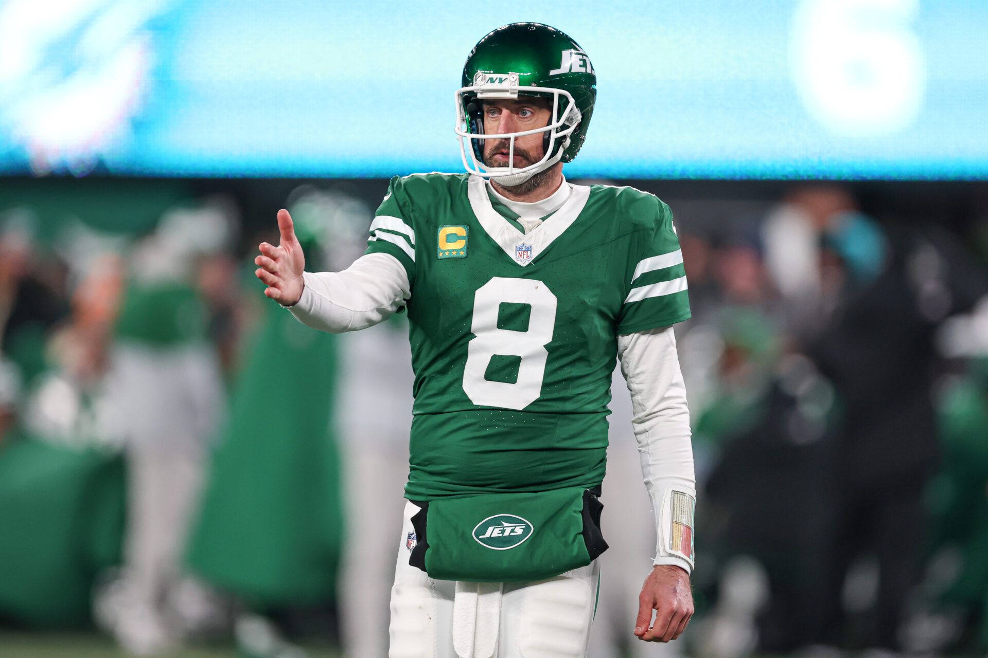 New York Jets quarterback Aaron Rodgers (8) gestures towards the Miami Dolphins bench during the second half at MetLife Stadium.