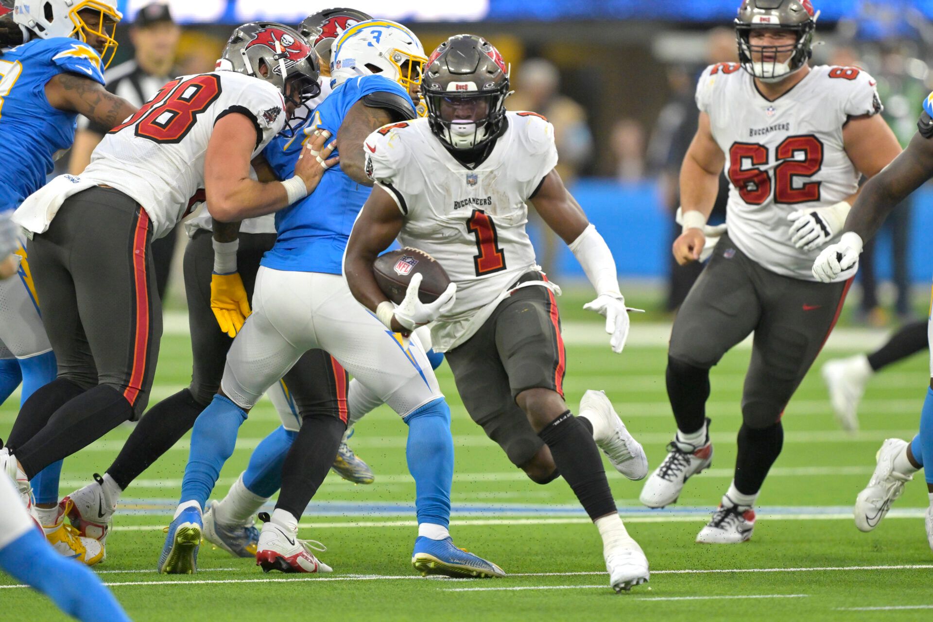 Tampa Bay Buccaneers running back Rachaad White (1) carries the ball for a 7-yard gain in the second half against the Los Angeles Chargers at SoFi Stadium.