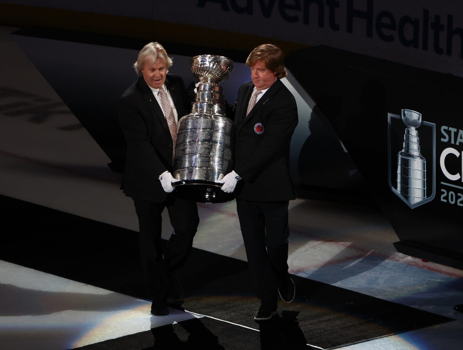 Keepers of the Cup members Phil Pritchard and Mike Bolt bring out the Stanley Cup for the Colorado Avalanche after defeating the Tampa Bay Lightning during game six of the 2022 Stanley Cup Final at Amalie Arena.
