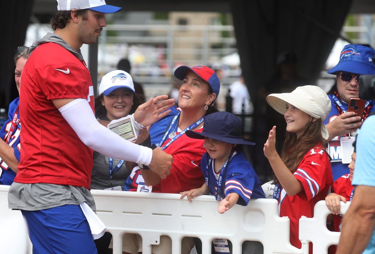 Bills Quarterback Josh Allen gives high-fives to fans as he circles the stadium at the end of Bills training camp at St. John Fisher University in Pittsford, NY on August 8, 2024. Today was the last day at St. John Fisher.