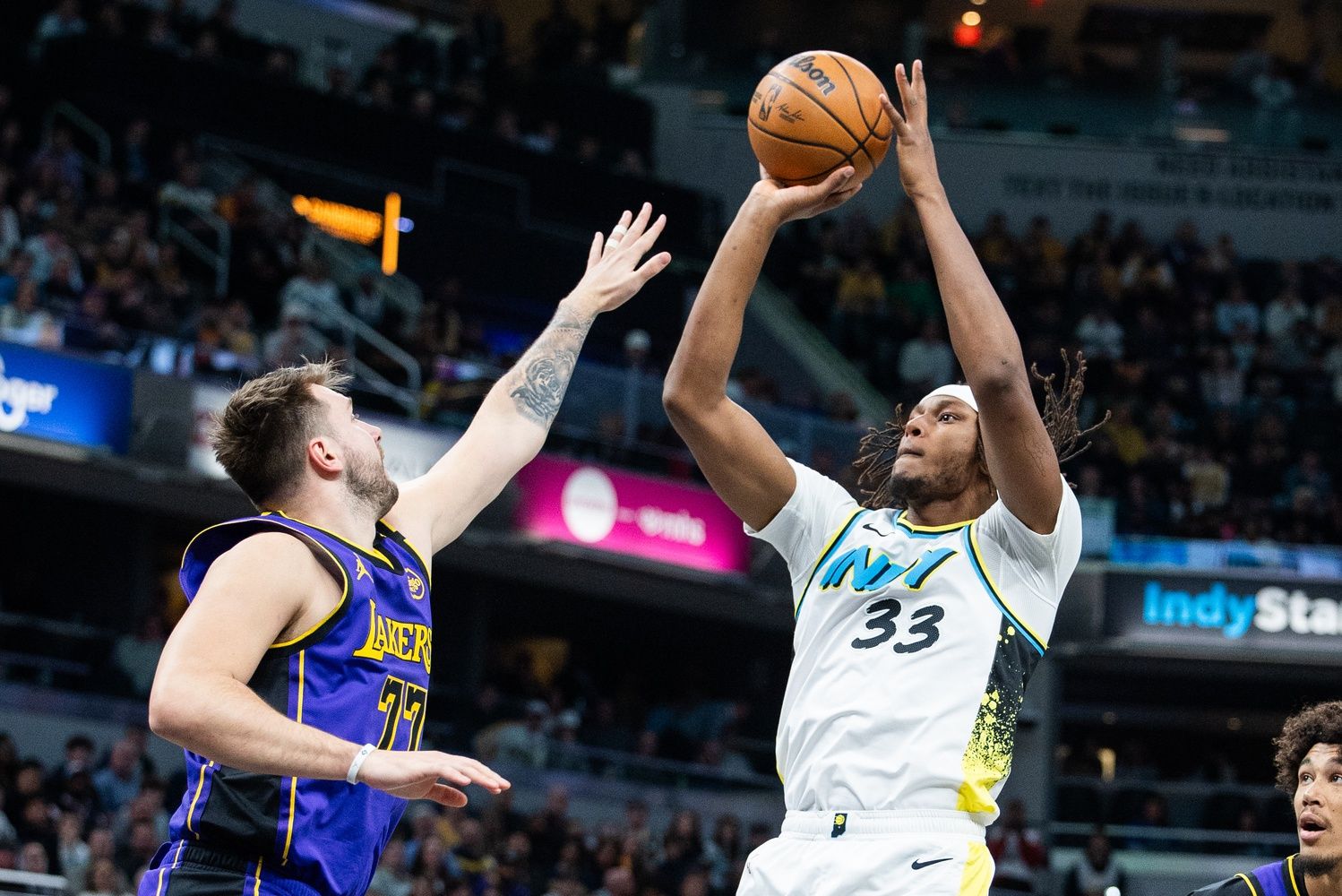 Indiana Pacers center Myles Turner (33) shoots the ball while Los Angeles Lakers guard Luka Doncic (77) defends in the first half at Gainbridge Fieldhouse.