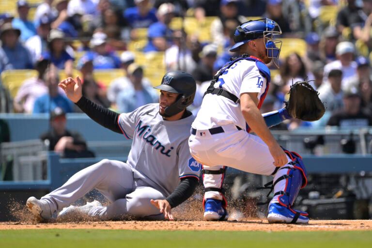 Miami Marlins catcher Agustin Ramirez (50) beats the throw to Los Angeles Dodgers catcher Austin Barnes (15) to score a run in the sixth inning at Dodger Stadium.