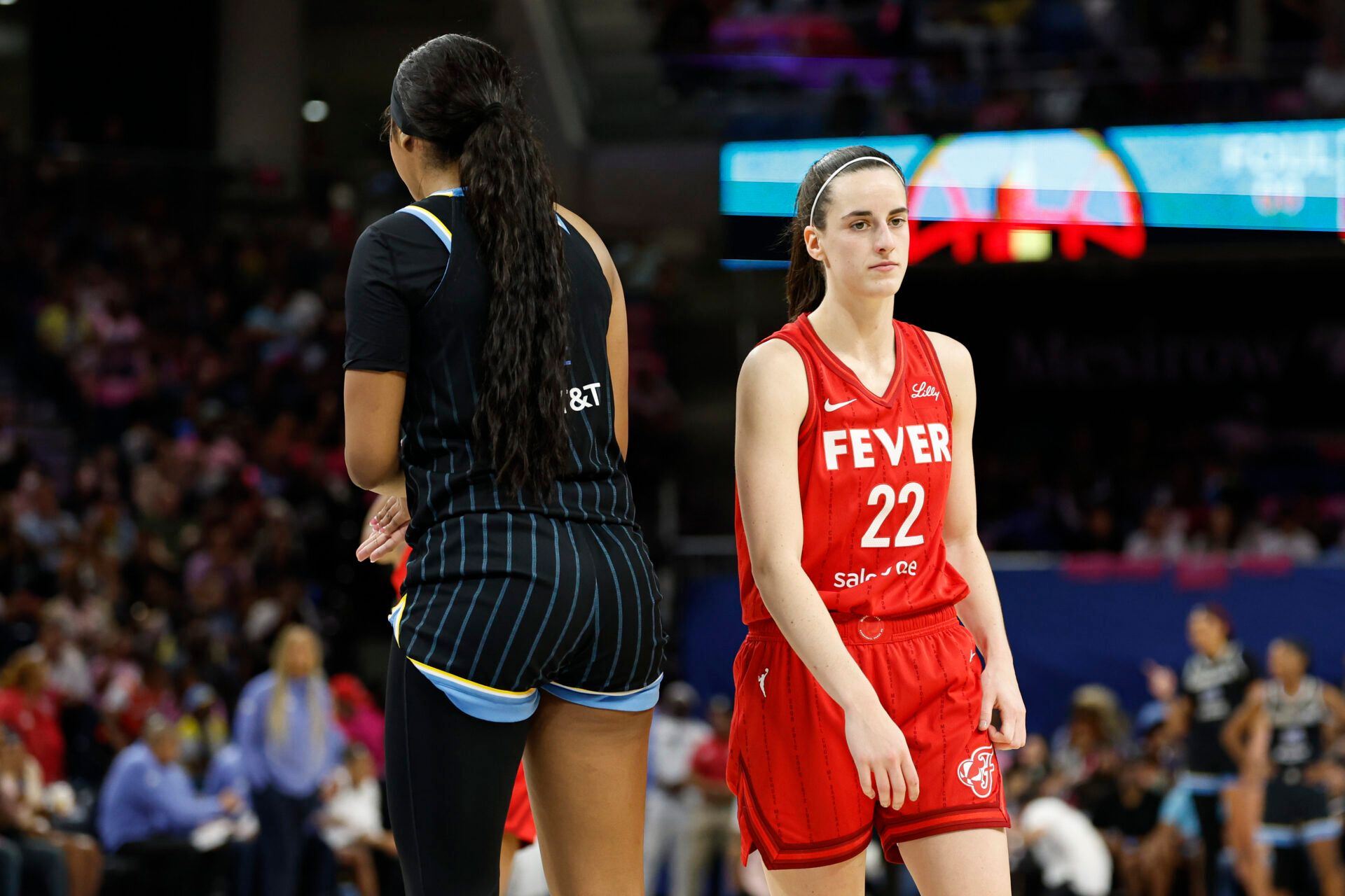 Indiana Fever guard Caitlin Clark (22) walks by Chicago Sky forward Angel Reese (5) during the second half at Wintrust Arena.