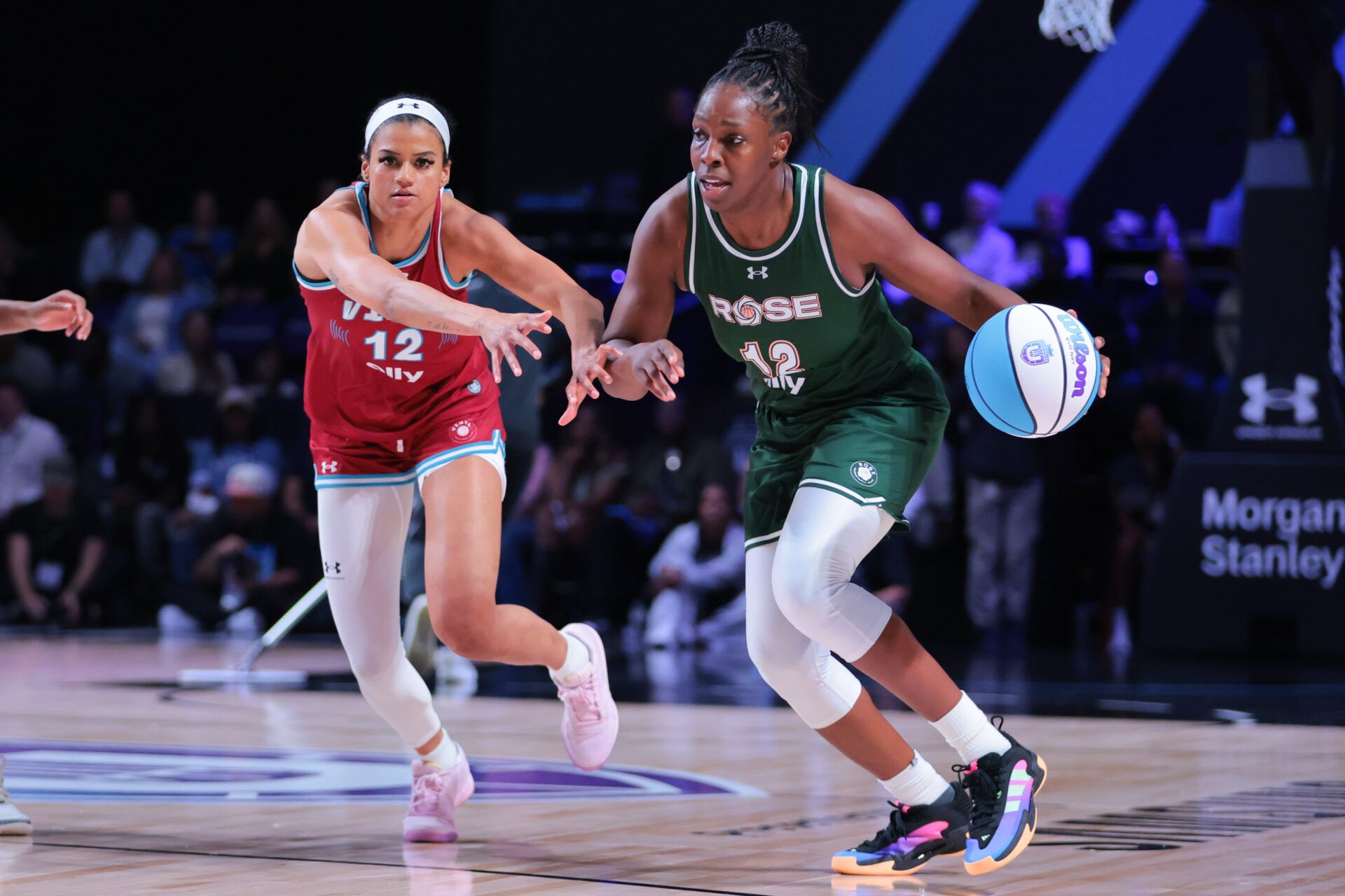 Rose BC guard Chelsea Gray (12) dribbles the basket past Vinyl BC guard Rae Burrell (12) during the fourth quarter of the Unrivaled Championship game at Wayfair Arena.