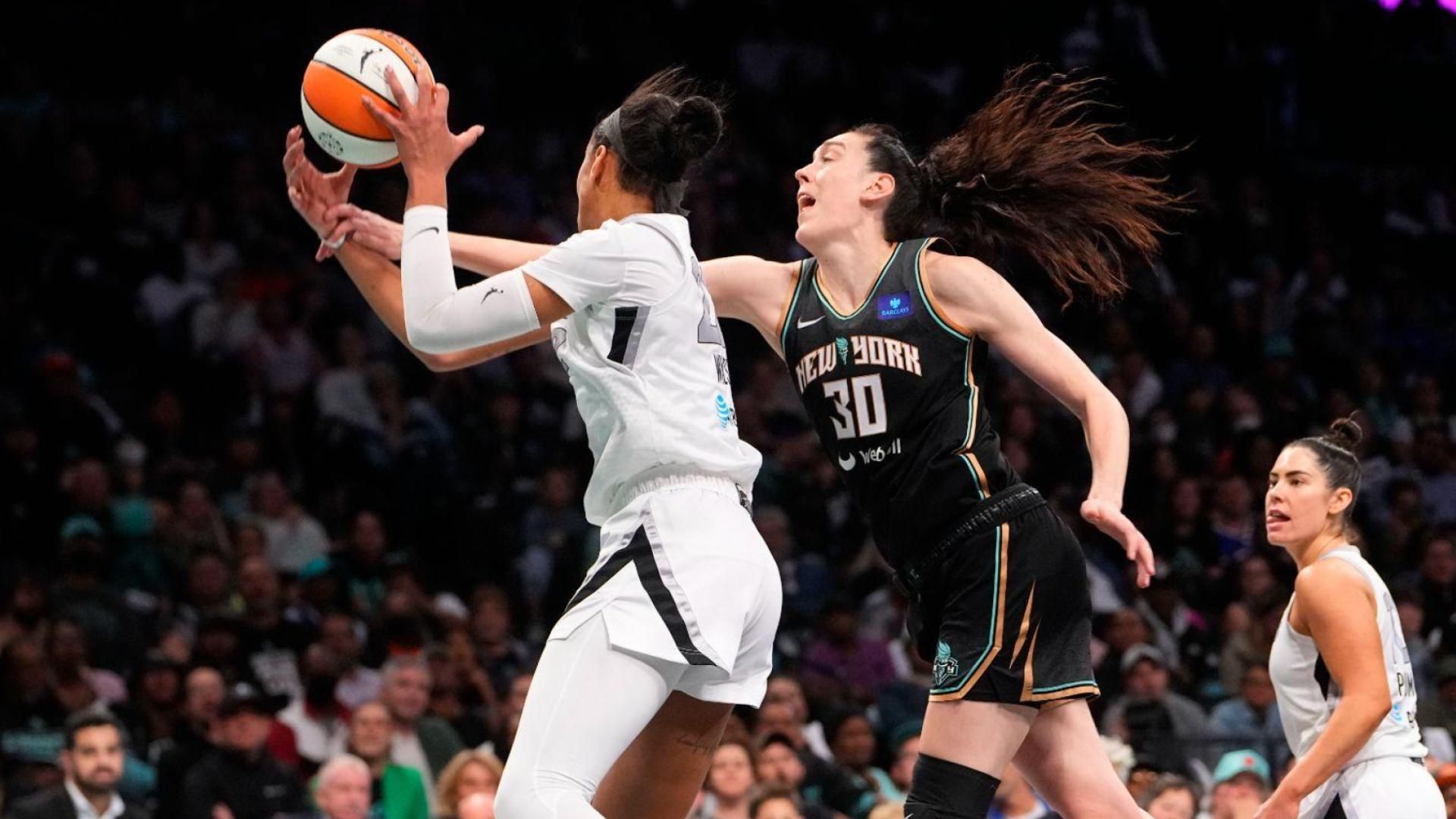 New York Liberty forward Breanna Stewart (30) gets fouled by Las Vegas Aces center A'ja Wilson (22) shooting a layup during game one of the 2024 WNBA Semi-finals at Barclays Center.