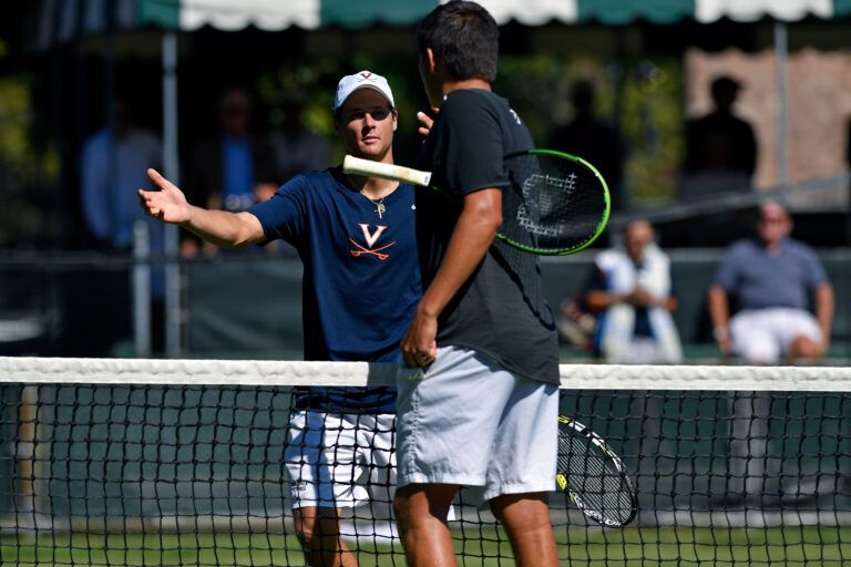 Virginia Cavaliers player J.C. Aragone shakes hands with TCU Horned Frogs player Jerry Lopez after a match at the Hall of Fame Tennis Club.