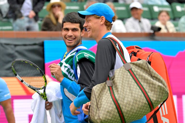 Carlos Alcaraz (ESP) and Jannik Sinner (ITA) leave the court during a rain delay in their semi-final match in the BNP Paribas Open at the Indian Wells Tennis Garden.