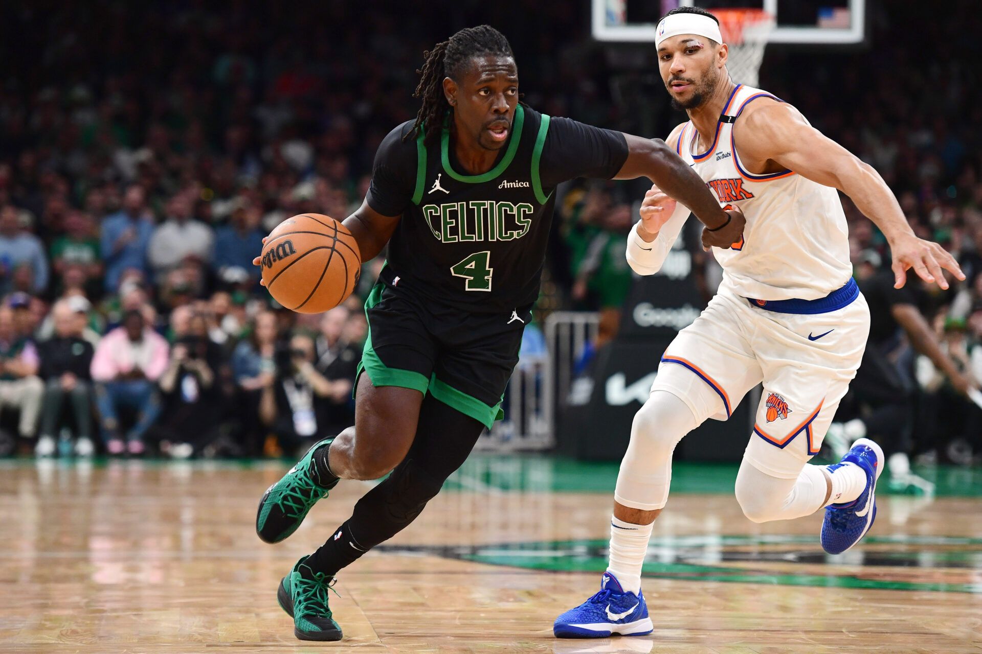 Boston Celtics guard Jrue Holiday (4) controls the ball while New York Knicks guard Josh Hart (3) defends in the second half during game five of the second round for the 2025 NBA Playoffs at TD Garden.