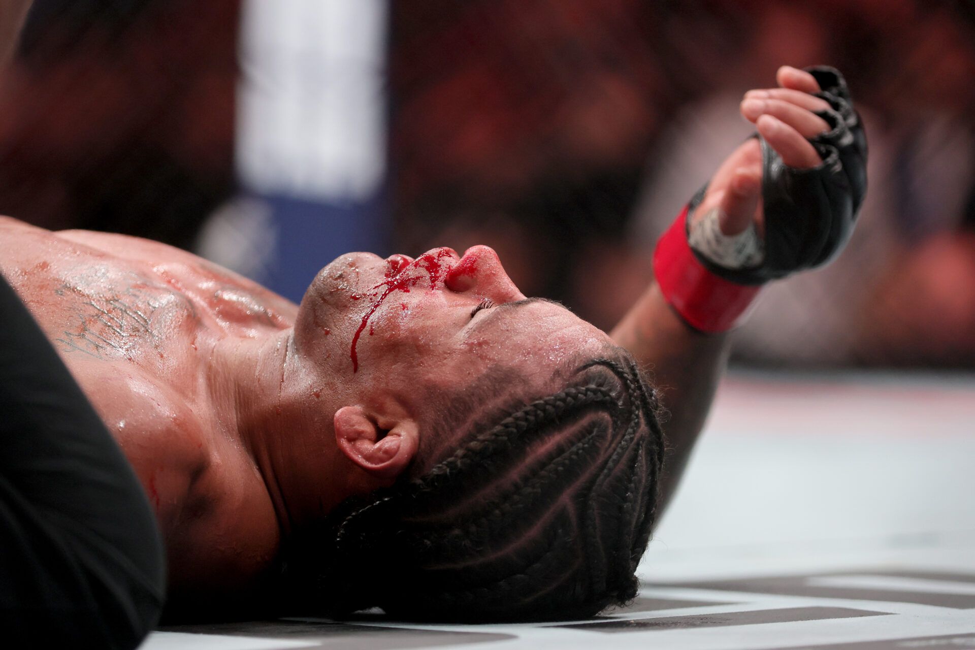 Gilbert Burns bleeds on the ring floor after fighting Jack Della Maddalena during UFC 299 at Kayesa Center.