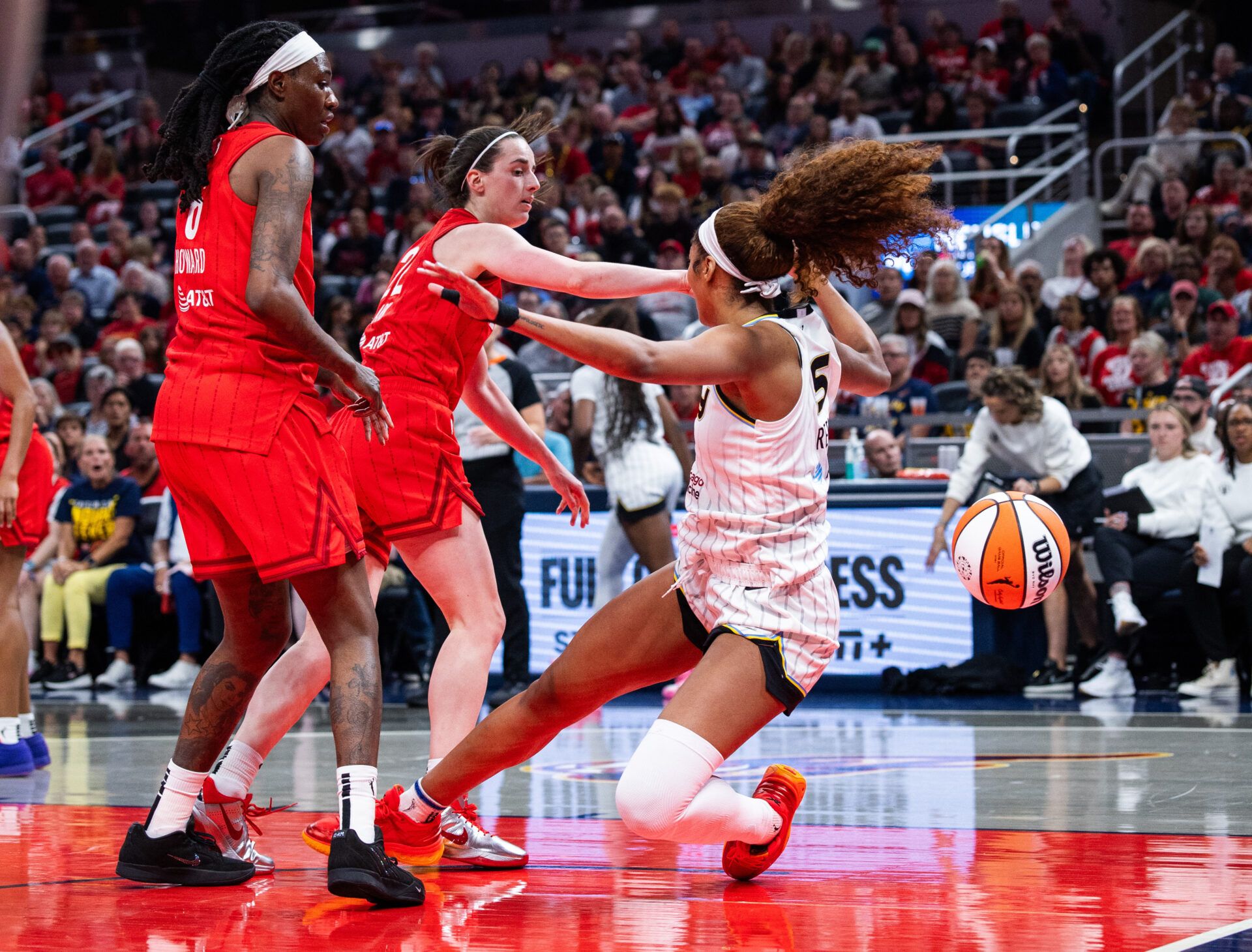 Indiana Fever guard Caitlin Clark (22) fouls Chicago Sky forward Angel Reese (5)  in the second half at Gainbridge Fieldhouse.