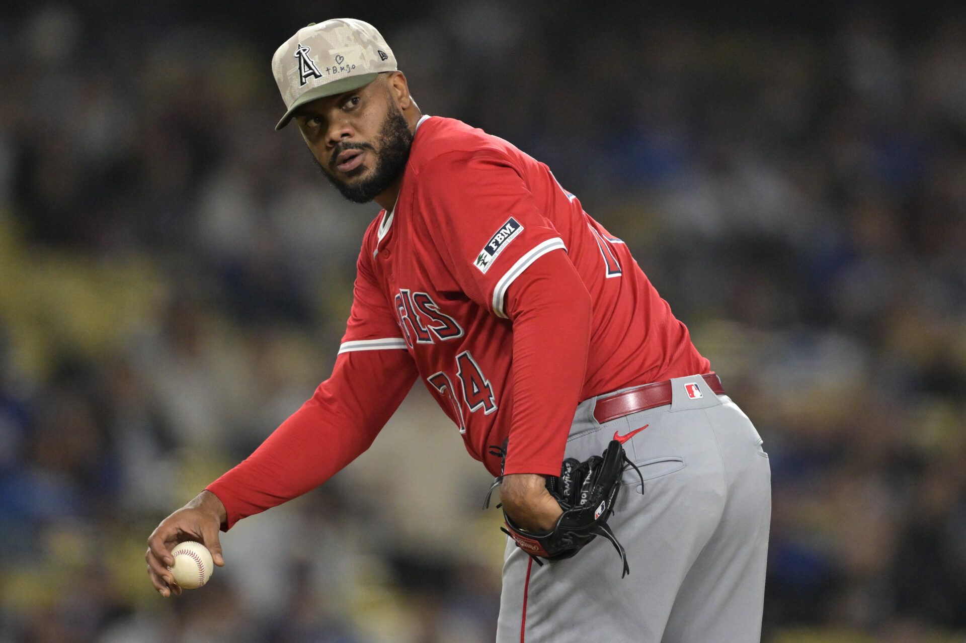 Los Angeles Angels relief pitcher Kenley Jansen (74) checks the runner at first in the ninth inning against the Los Angeles Dodgers at Dodger Stadium.