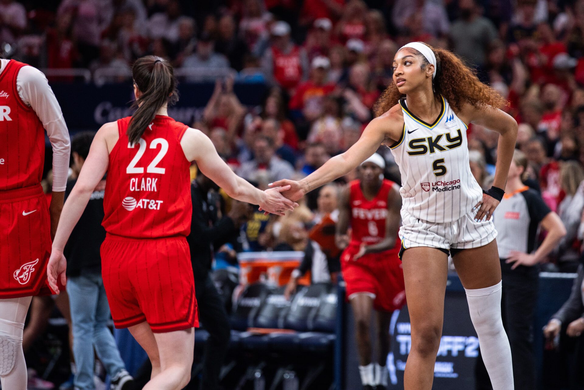 Indiana Fever guard Caitlin Clark (22) and Chicago Sky forward Angel Reese (5) shake hands before the game at Gainbridge Fieldhouse.