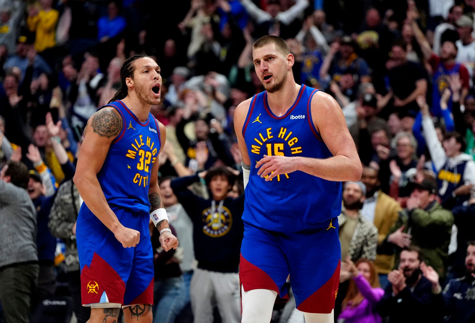 Denver Nuggets center Nikola Jokic (15) reacts along side forward Aaron Gordon (32)  following a full court basket made in the second half against the Sacramento Kings at Ball Arena.