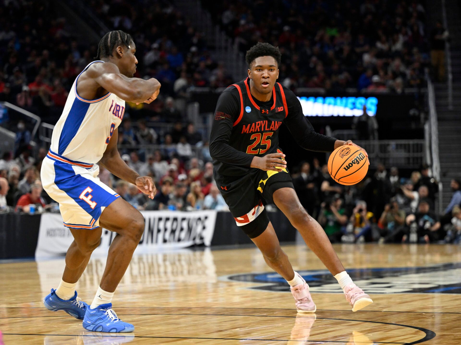 Maryland Terrapins center Derik Queen (25) dribbles down court past Florida Gators center Rueben Chinyelu (9) during the second half during a West Regional semifinal of the 2025 NCAA tournament at Chase Center.