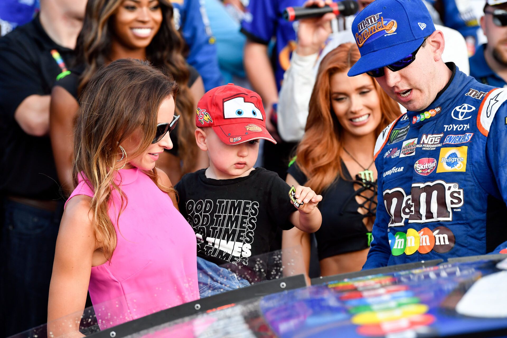 Monster Energy NASCAR Cup Series driver Kyle Busch (right) watches as his son Brexton and wife Samantha place a winner sticker on his car after finishing first in the ISM Connect 300 at the New Hampshire Motor Speedway.