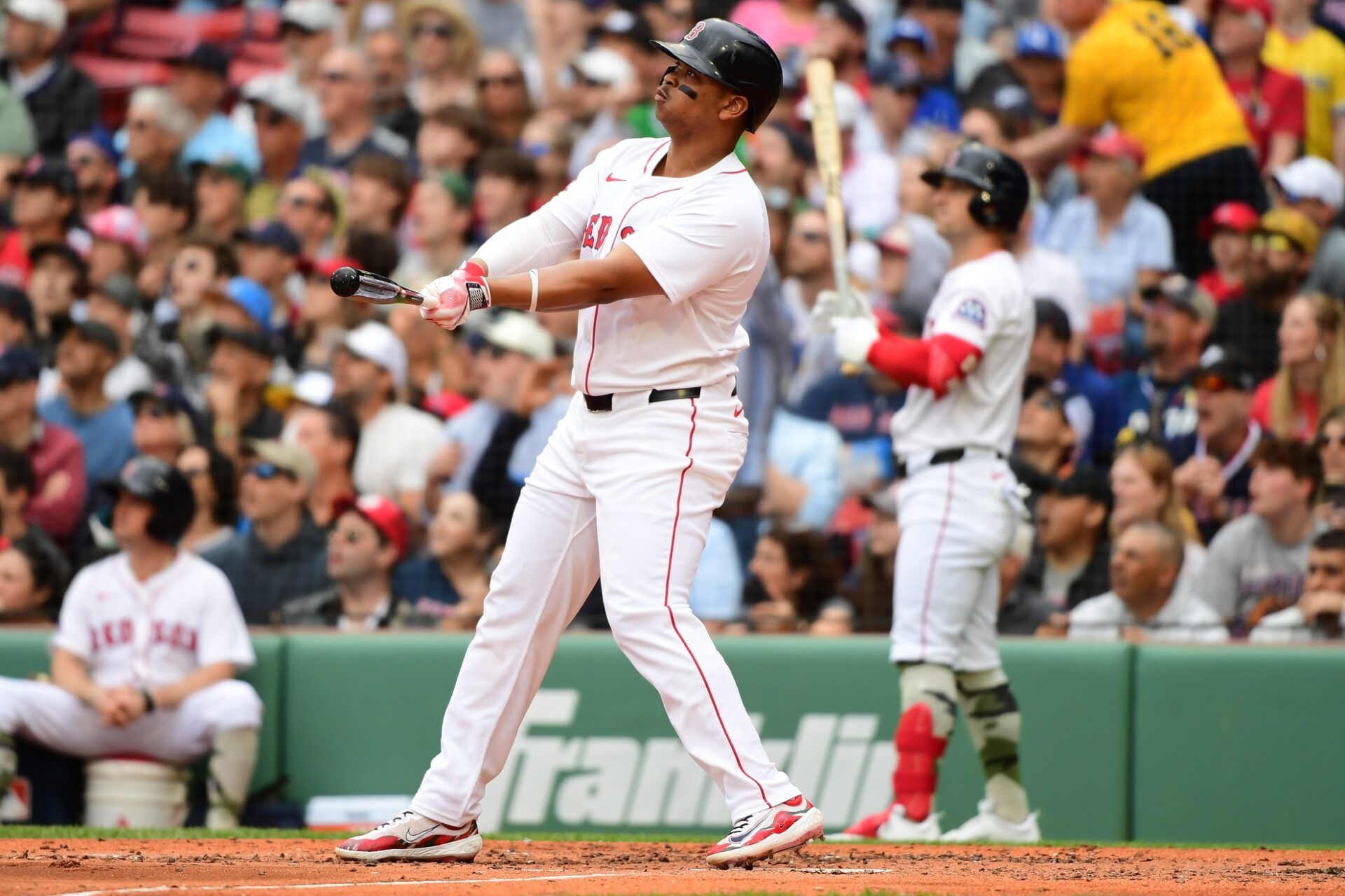 Boston Red Sox designated hitter Rafael Devers (11) hits a grand slam during the third inning against the Atlanta Braves at Fenway Park.