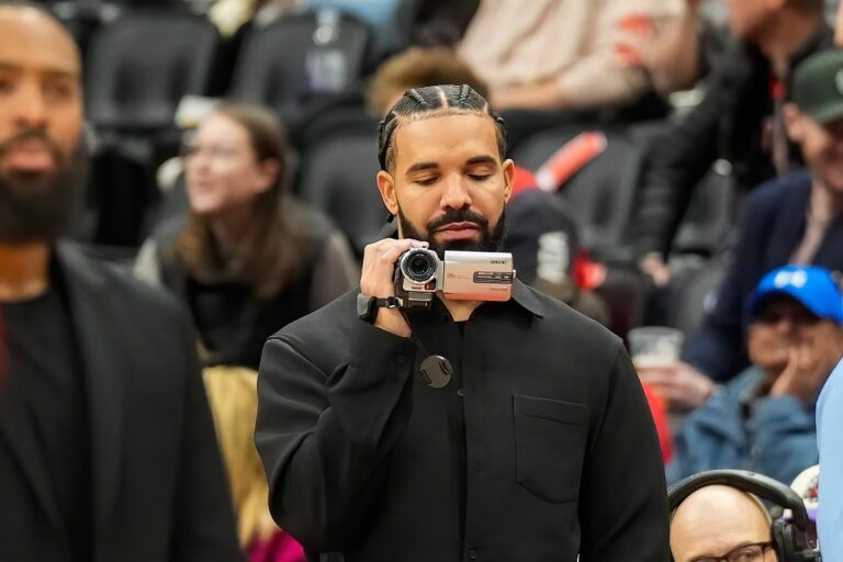 Drake holds a camera before an NBA game between the Chicago Bulls and Toronto Raptors at Scotiabank Arena.