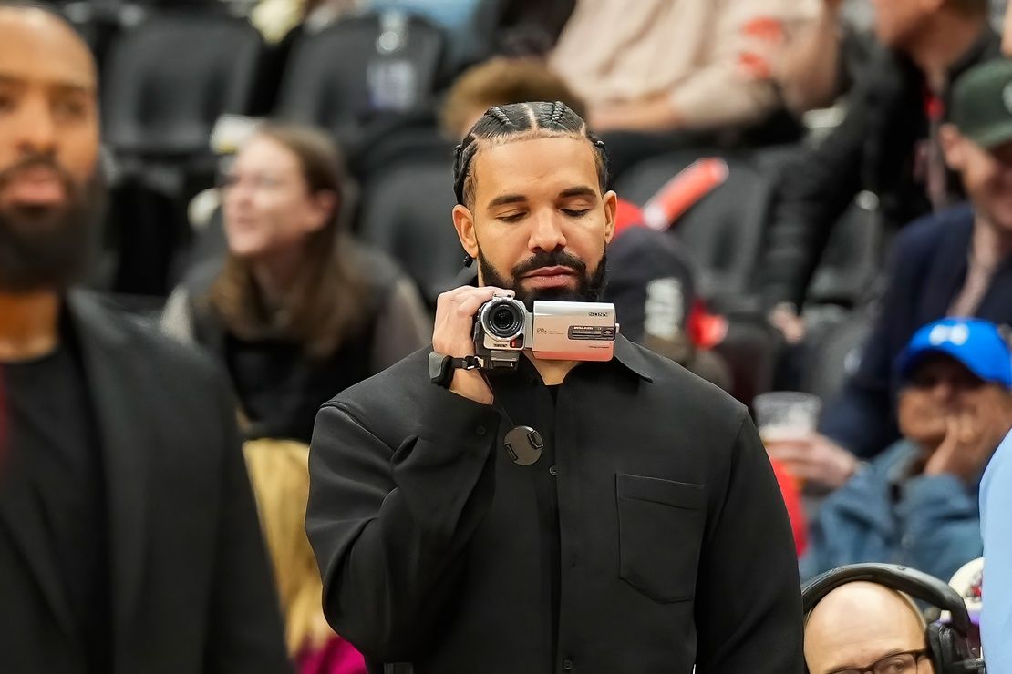 Drake holds a camera before an NBA game between the Chicago Bulls and Toronto Raptors at Scotiabank Arena.